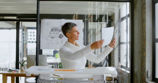 Middle Aged Woman Analyzing Diagrams in Modern Office - Download Free Stock Images Pikwizard.com