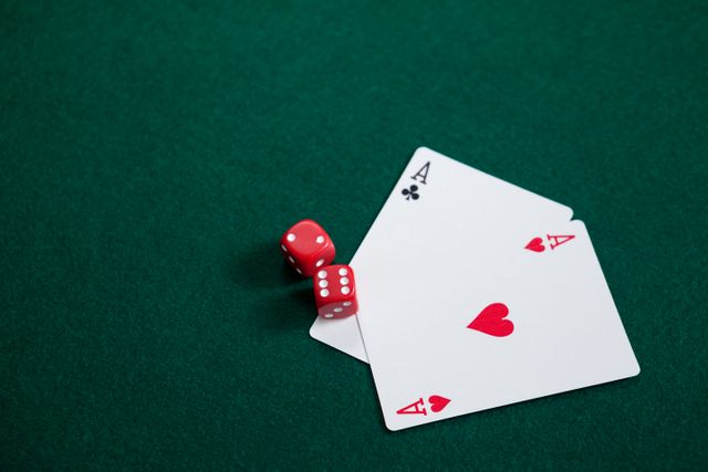 Pair of red dice and two aces on green poker table. Ideal for illustrating casino themes, gambling concepts, and gaming promotions. Suitable for use in advertisements, websites, and articles related to poker, betting, and entertainment.
