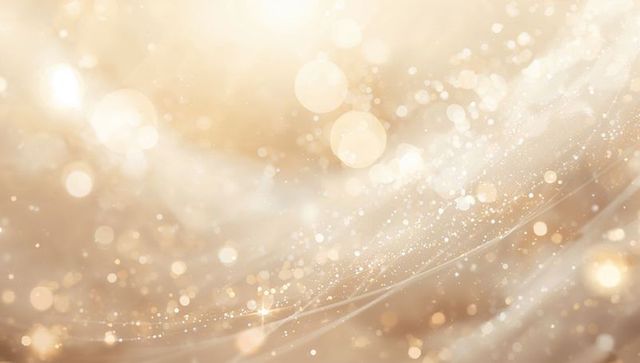 Shimmering golden bokeh background with sparkling dust, glowing orbs and flowing light streaks
