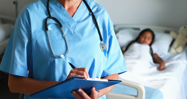 Nurse with Stethoscope Filling Medical Records in Hospital Room - Download Free Stock Images Pikwizard.com