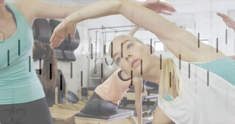 Blonde woman stretching in pilates class on reformer, improving flexibility and posture