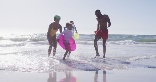 Family Enjoying Summer Beach Day with Inflatable Toys - Download Free Stock Images Pikwizard.com