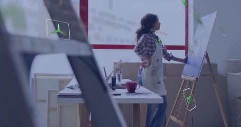 Female Artist Working on Canvas in Sunlit Art Studio