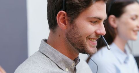 Smiling customer service representatives using headsets