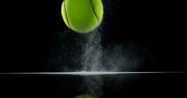 A high-speed capture of a tennis ball bouncing off the ground with a dramatic powder splash and impact effect. Ideal for use in sports marketing, motion dynamics studies, advertising campaigns, and fitness products. Can also be used for illustrating concepts of force, energy, and motion in educational materials.