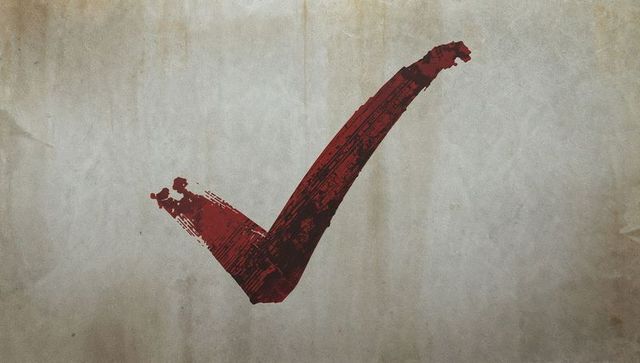 Red brushstroke check mark against textured wall