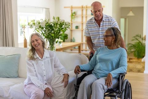 Diverse Senior Friends Sharing Laughter and Companionship in Cozy Living Room