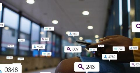 Tapping smartphone in airport concourse with floating notification bubbles and bokeh lights