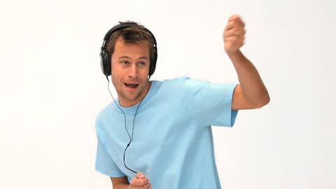 Joyful Man Dancing While Listening to Music with Headphones