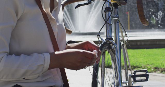 Person Repairing Bicycle Near Fountain in Park - Download Free Stock Images Pikwizard.com