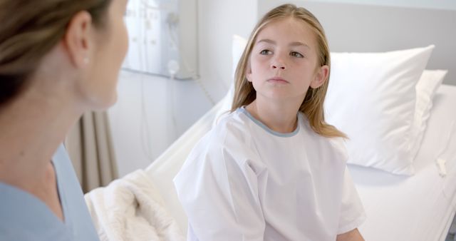 Nurse comforting young girl patient in hospital bed - Download Free Stock Images Pikwizard.com