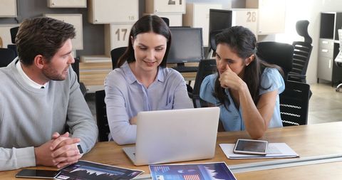 Diverse Professionals Collaborating Over Laptop in Modern Office - Download Free Stock Images Pikwizard.com