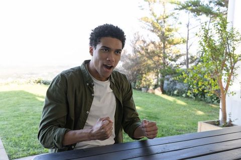 Man joyfully celebrating on rustic patio