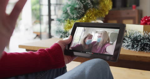 Friends Connecting via Christmas Video Call on Tablet