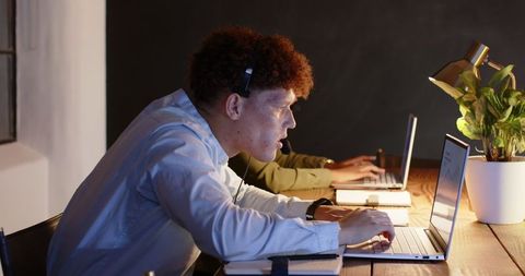 Diverse Professionals Collaborating Late on Business Project