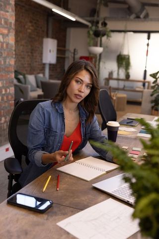 Creative professional brainstorming in modern workspace