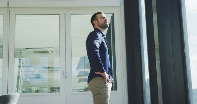 Confident businessman standing outside office building looking into distance - Download Free Stock Images Pikwizard.com