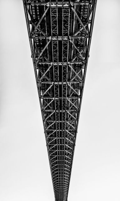 This photo can be used for architectural and engineering content, emphasizing the intricate design and symmetry of steel structures. Ideal for presentations, articles, and educational materials focusing on industrial design, infrastructure, and construction.