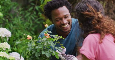 Couple Enjoying Time Together Gardening with Roses