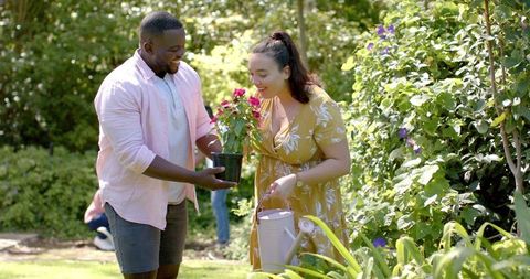 Couple Gardening Together Holding Potted Plant