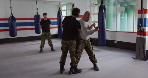 Army Instructor Training with Soldiers in Gym Combat Class