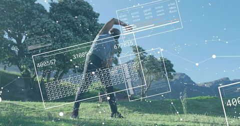 Mature man stretching on grassy hill showing augmented reality fitness overlays with AR data