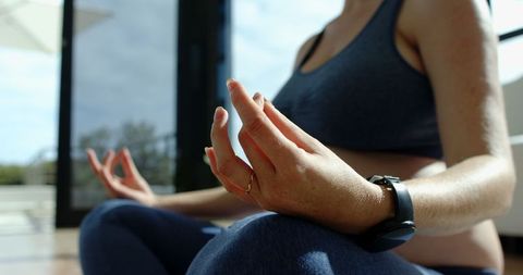 Close-Up of Woman Meditating Indoors in Natural Light