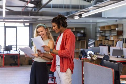 Diverse Coworkers Reviewing Documents in Modern Office