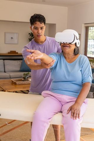 Elderly woman in vr therapy session with caregiver support