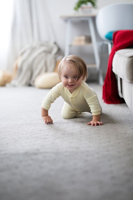 Baby crawling on carpet in a cozy living room, smiling happily. Ideal for use in family-oriented content, parenting blogs, advertisements for baby products, or articles about home life during quarantine.