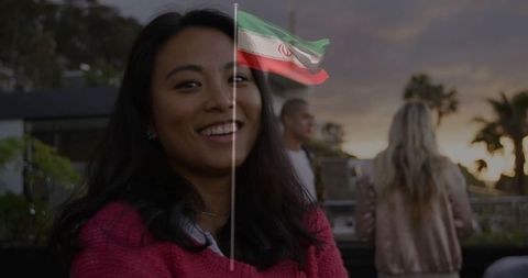 Smiling woman on rooftop with sunset background