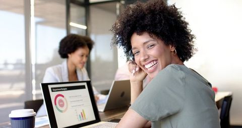 Smiling professionals collaborating in modern office space