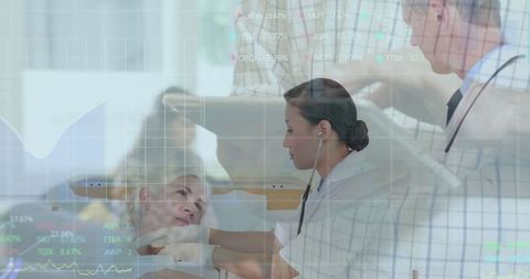 Asian Nurse Monitoring Patient with Modern Diagnostic Technology