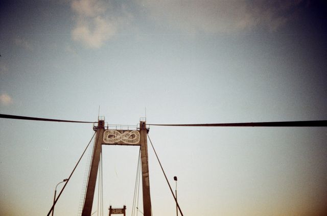 Suspension Bridge with Infinity Symbol at Sunset Against Clear Sky - Download Free Stock Images Pikwizard.com