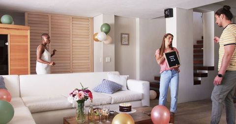 Friends Celebrating Birthday Amidst Colorful Decorations at Home