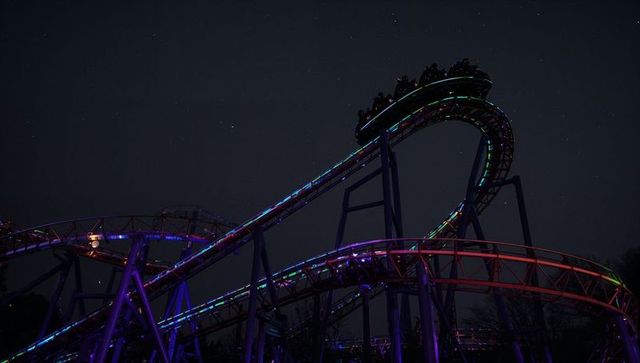 Roller coaster under evening sky featuring glowing led lights