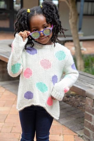 African american girl playfully wearing vibrant sunglasses in courtyard