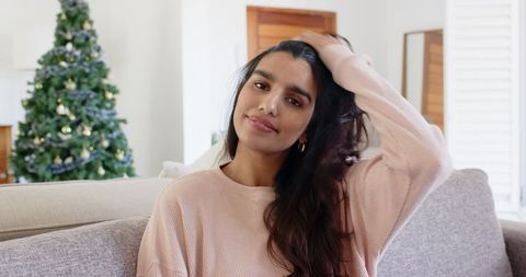Content Young Woman Relaxing in Cozy Holiday Living Room Setting