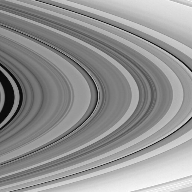 Close-up view of Saturn's outer C ring featuring intricate patterns in monochrome. Excellent for use in educational materials, space exploration websites, astronomy books, and science presentations. Highlights Saturn's unique ring features and the awe-inspiring universe beyond Earth.