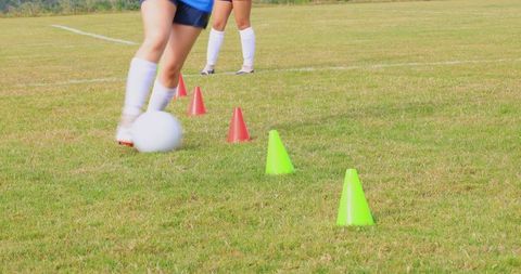Teenage Soccer Practice on Grass Field with Training Cones
