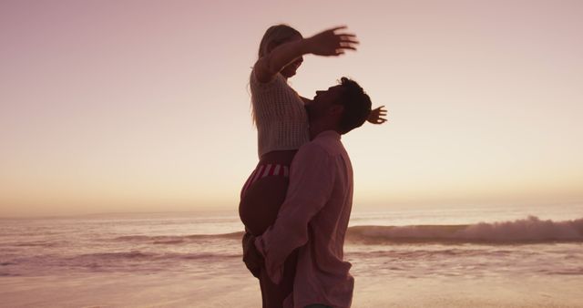 Happy diverse couple embracing and smiling on beach - Download Free Stock Photos Pikwizard.com