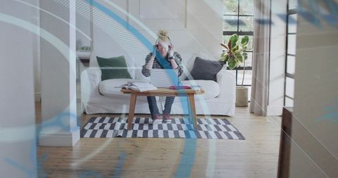 Man Studying in Cozy Living Room with Headphones and Notes