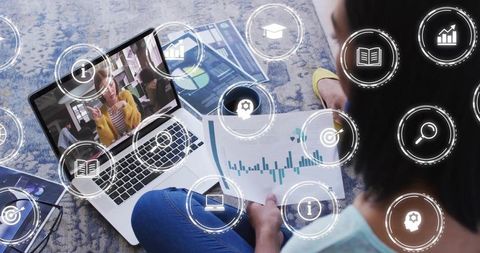 Working woman analyzing charts on laptop during video call with analytics icons