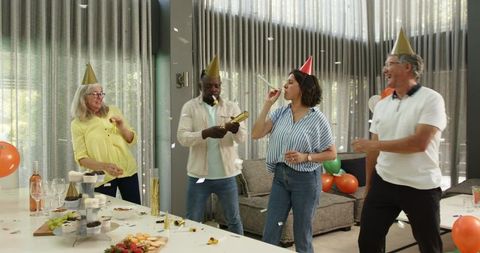 Diverse colleagues celebrating office party with fun and confetti