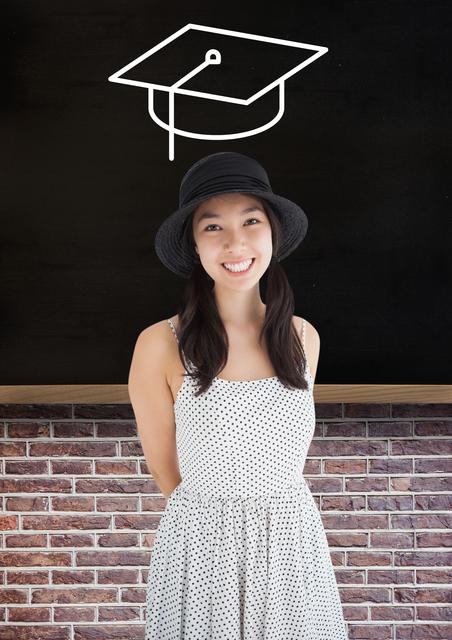 This portrays a cheerful teenage girl standing in front of a blackboard, wearing a polka dot dress and black hat. The blackboard has an illustration of a graduation cap, making it ideal for themes related to education, graduation announcements, student life, and academic success. Useful for educational websites, school brochures, graduation-themed invitations or marketing materials.