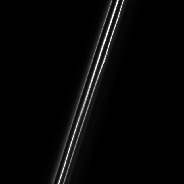 When seen up close, the F ring of Saturn resolves into multiple dusty strands. This Cassini view shows three bright strands and a very faint fourth strand off to the right.  The central strand is the core of the F ring. The other strands are not independent at all, but are actually sections of long spirals of material that wrap around Saturn. The material in the spirals was likely knocked out from the F ring's core during interactions with a small moon.  This view looks toward the unilluminated side of the rings from about 38 degrees above the ring plane. The image was taken in visible light with the Cassini spacecraft narrow-angle camera on Dec. 18, 2016.  The view was acquired at a distance of approximately 122,000 miles (197,000 kilometers) from Saturn and at a Sun-Ring-spacecraft, or phase, angle of 47 degrees. Image scale is 0.7 miles (1.2 kilometers) per pixel.  http://photojournal.jpl.nasa.gov/catalog/PIA20519