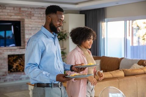 Couple enjoying breakfast in cozy modern living room