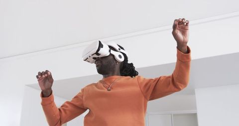 African American man wearing VR headset in home exploring immersive VR experience