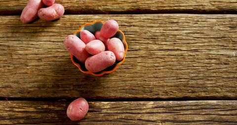 Fresh Red Potatoes in Bowl on Rustic Wooden Table