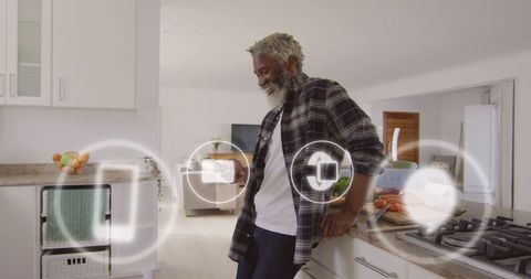 African american man engaging with smartphone and social media icons